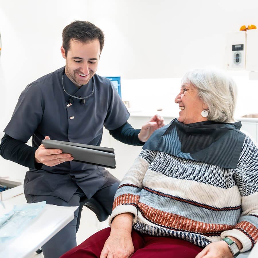 dentist consulting an old woman patient