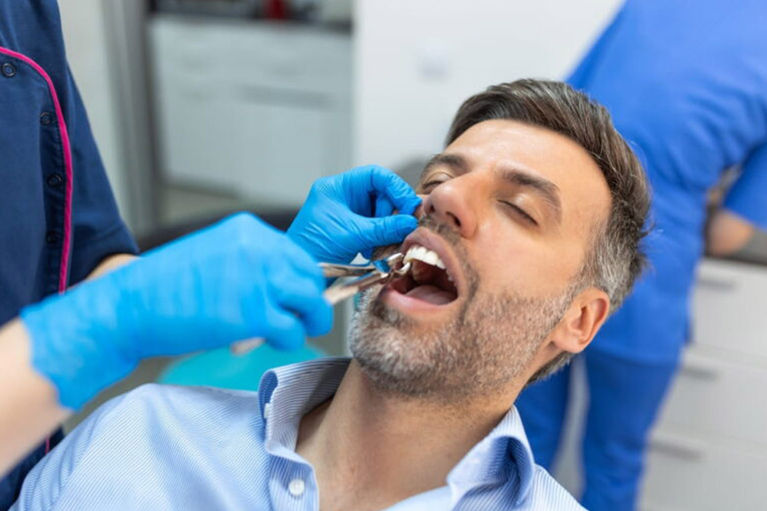 Treatment of a patient with a dentist surgeon. Extraction of teeth and prosthetics